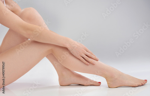 Silky smooth. Cropped image of a woman touching her smooth legs.