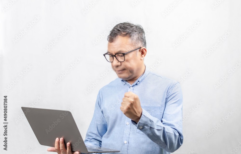 Selective focus, Businessmen express their joy with the growth of their business from laptops. man holding a notebook computer and working financial concept real estate technology white background Selective focus, Businessmen express their joy with the growth of their business from laptops. man holding a notebook computer and working financial concept real estate technology white background
