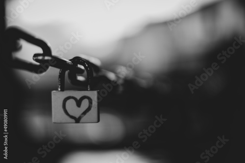 Selective focus grayscale shot of a lock with a heart on it - love concept photo