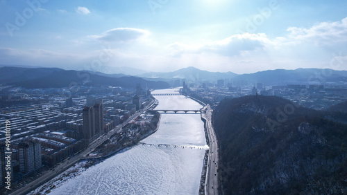 Aerial shot of a cityscape with Rungra Bridge in Pyongyang, North Korea, photo