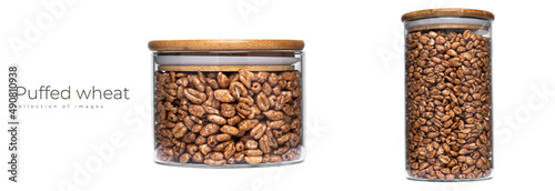 Puffed wheat in a glass jar isolated on a white background.