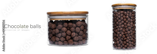 Chocolate balls in glass jar isolated on a white background. Quick breakfast.
