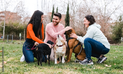 Photography Group of friends meet in the park with their dogs.