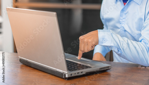 Young man working on a laptop at home, Technology & Business Concepts.