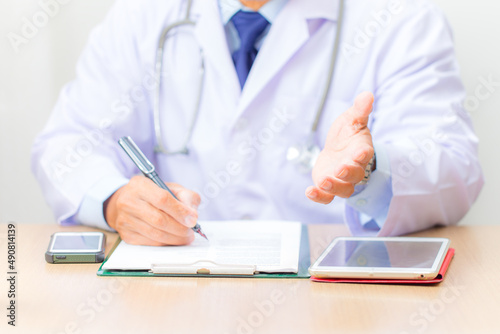 doctor writing on clipboard
