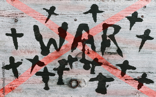 Krieg. Ein Holzschild mit der durchgestrichenen Aufschrift WAR und Kreuzen photo