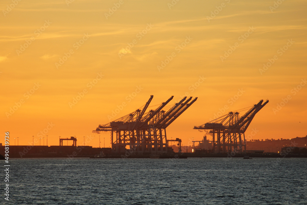 Senset over Long Beach loading docks with cranes
