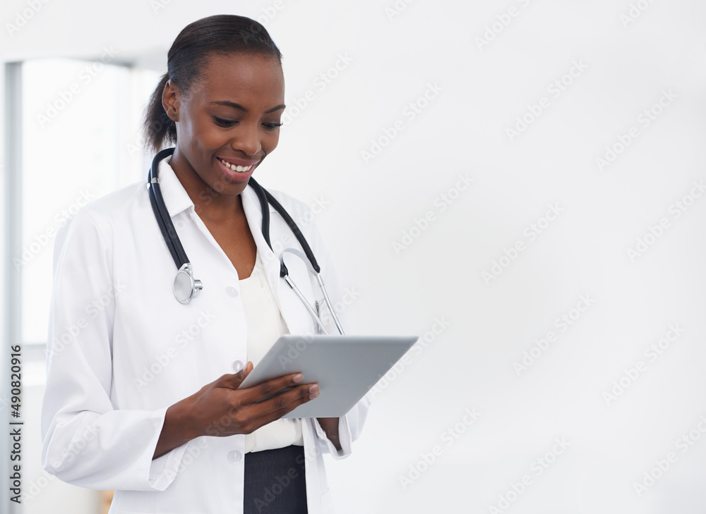 Using technology to make a diagnosis. Shot of a female doctor holding a digital tablet. Using technology to make a diagnosis. Shot of a female doctor holding a digital tablet.