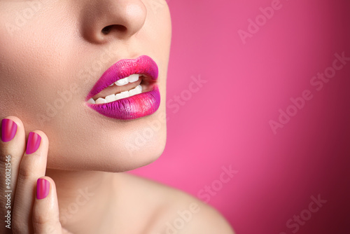 Young woman with beautiful lips makeup on pink background  closeup. Space for text
