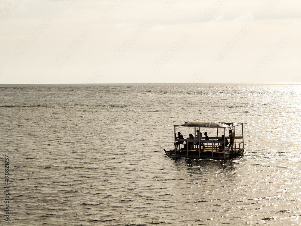 A silhouette of boat with sunset as background A silhouette of boat with sunset as background