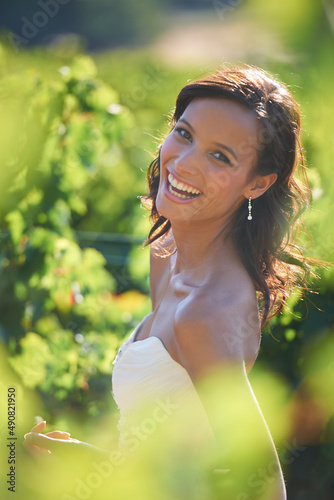 Beaming bride. A gorgeous bride smiling while standing in a vineyard. photo
