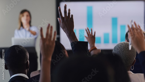 Opening the floor for a QA session. Rearview shot of a group of businesspeople raising their hands during a conference in an office.