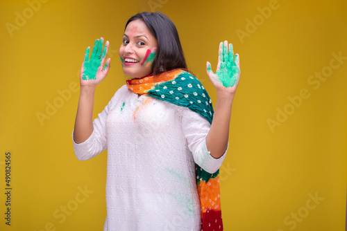 Portraits of young woman celebrating holi
