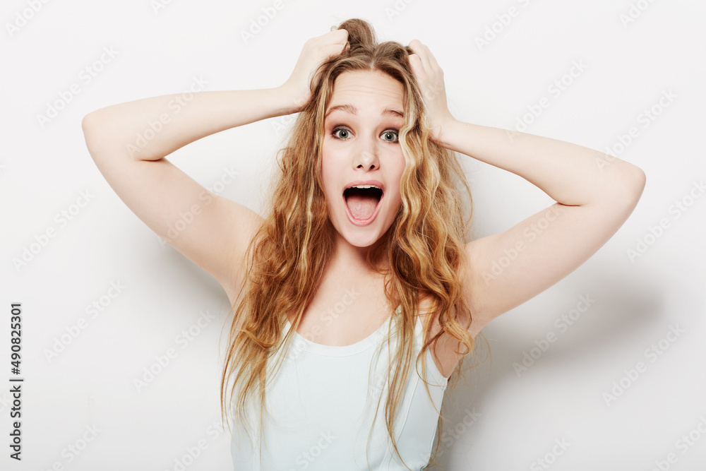 Wow I cant believe it. Surprised young woman with her hands in her hair. Wow I cant believe it. Surprised young woman with her hands in her hair.