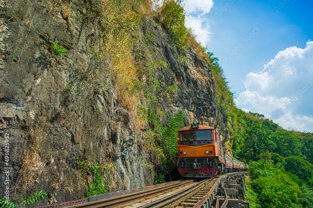 Death Railway, Thai Railway,World war II historic railway, known as the Death Railway with a lot of tourists on the train taking photos of beautiful views over Kwai Noi River Death Railway, Thai Railway,World war II historic railway, known as the Death Railway with a lot of tourists on the train taking photos of beautiful views over Kwai Noi River