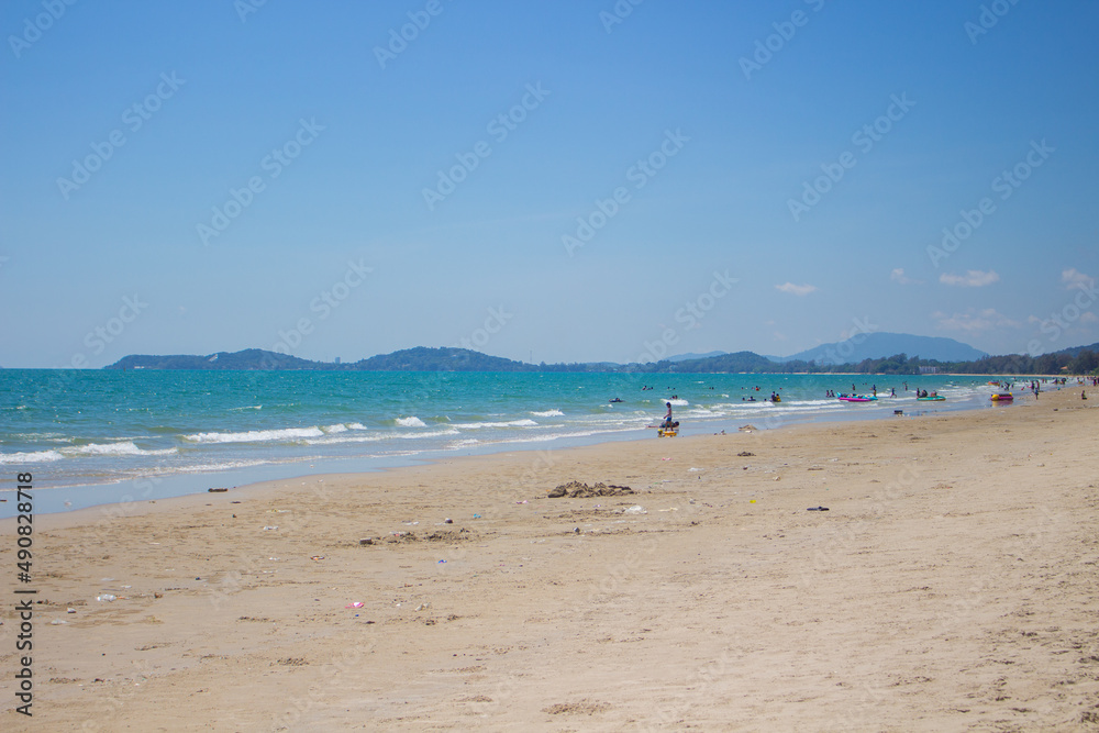 Blue sea on the beach covered with fine sand with bright blue sky in Thailand.