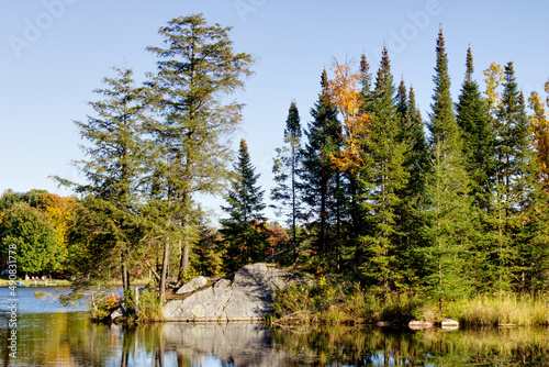 Beautiful Autumn landscape with the colors of Fall by the quiet lake and a clear blue sky, HDR rendered photos