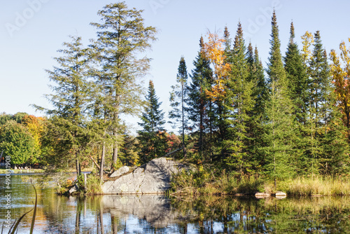 Beautiful Autumn scenery with the colors of Fall by the quiet lake and a clear blue sky, HDR rendered photos