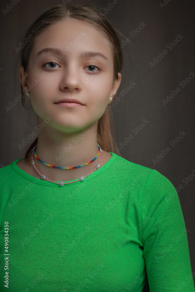 Portrait of a young beautiful green-eyed girl in a home studio. Portrait of a young beautiful green-eyed girl in a home studio.