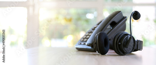 Customer service concept. Close-up headphone and telephone for communication helpdesk IT support or call center and online services.