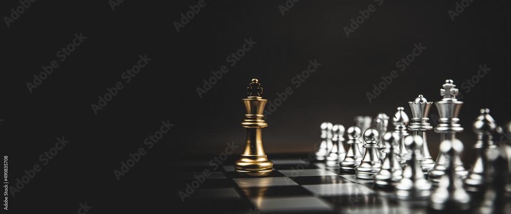 The King in battle chess game stand on chessboard with black