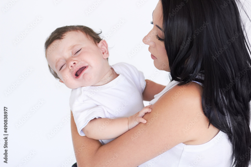 Babies are hard work. A mother holding her crying baby boy. Babies are hard work. A mother holding her crying baby boy.