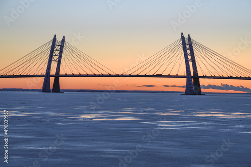 The silhouette of the cable-stayed bridge over the Ship Fairway on the Western High-Speed ​ ​ Diameter against the background of the December sunset. St. Petersburg, Russia