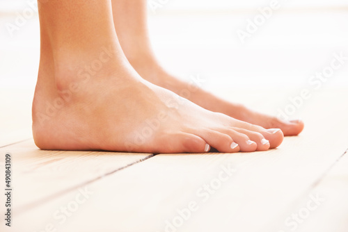 Walking barefoot. Close-up of feet on a wooden floor.