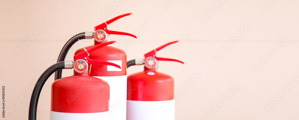 Obraz premium Close up fire extinguisher for protection and prevent and safety rescue and use of equipment on fire training concept.