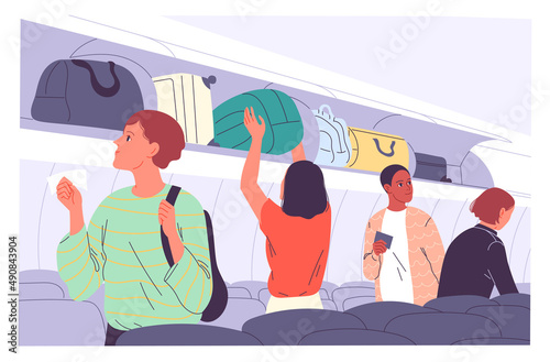 Passengers place their carry-on luggage on the top shelves of the plane.