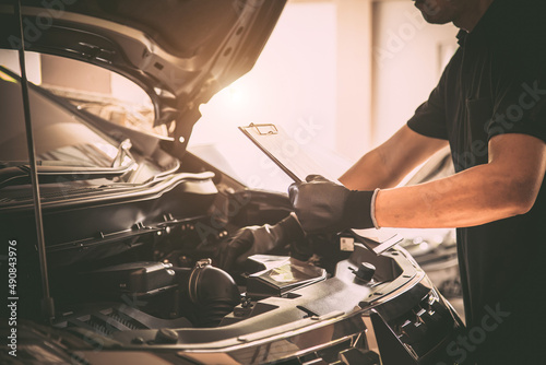Close-up hand auto mechanic using the wrench to repairing car engine problem. Concepts of check and inspection car care maintenance and servicing.