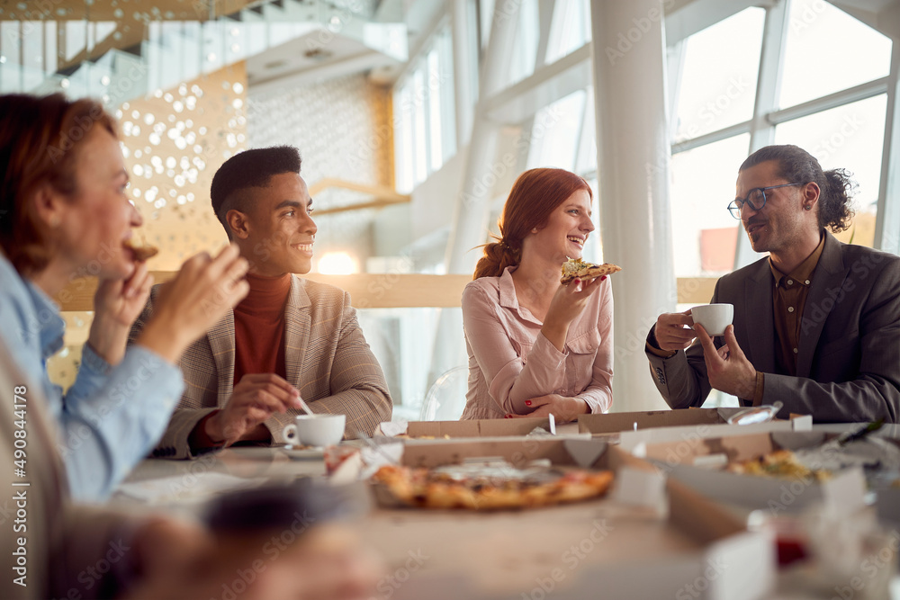 © luckybusiness - Young business team enjoys to have a lunch break in the company building together. Business, people, company