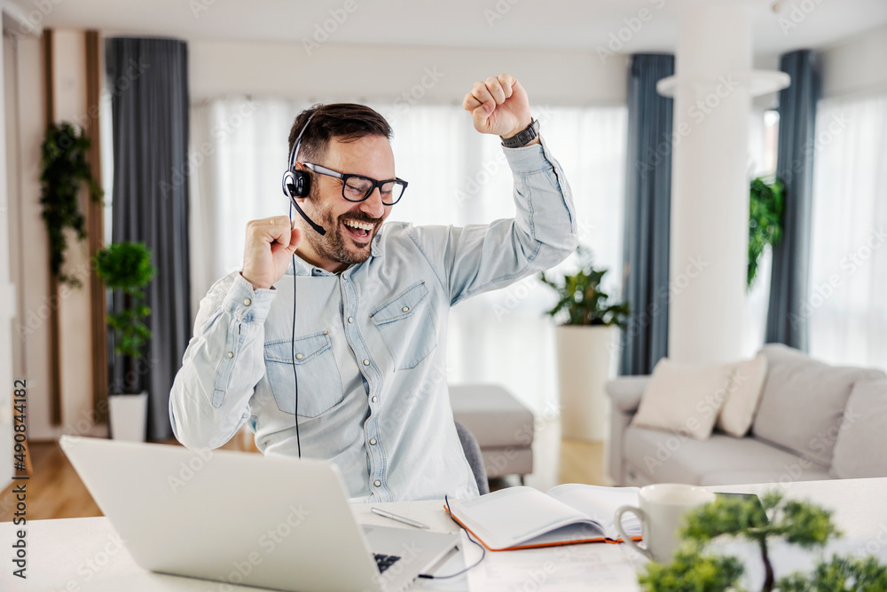A man is laughing and celebrating success. A man is laughing and celebrating success.