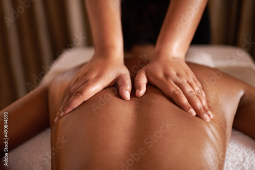 She had those healing hands. Rearview shot of a woman getting a massage at a spa.