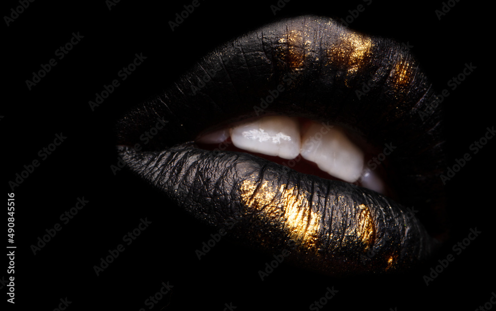 Golden and black lipstick close-up. Metallic gold lips.Sexy lips, lip paint  Black and gold. Metal lipstick close-up. Stock-foto | Adobe Stock