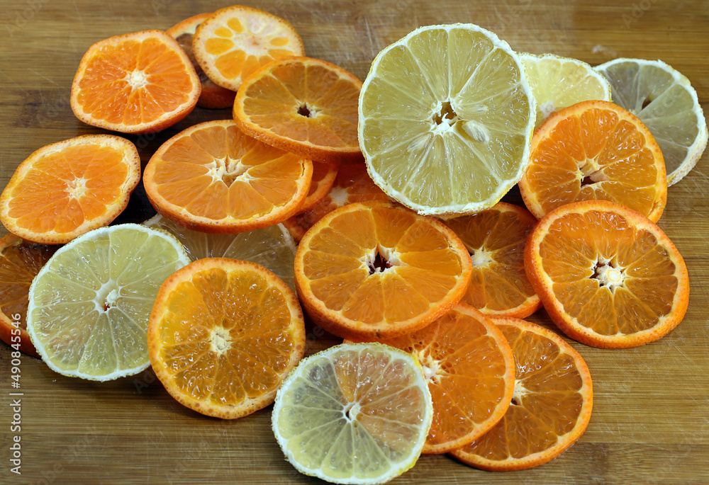 sliced parts of tangerine and lemon on a cutting board sliced parts of tangerine and lemon on a cutting board