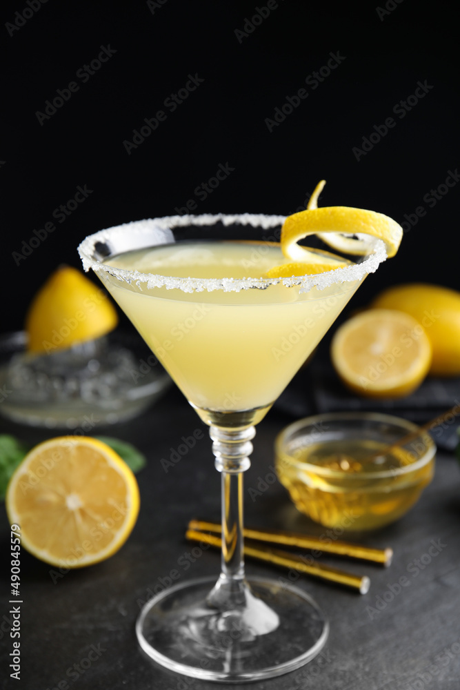 Delicious bee's knees cocktail and ingredients on black table Delicious bee's knees cocktail and ingredients on black table