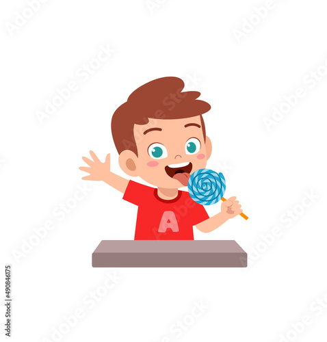 little boy eat sweet lollipop and feel happy