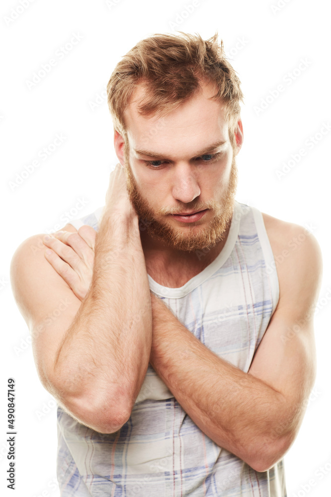 Feeling depressed. A young man wearing a vest and looking depressed isolated on white. Feeling depressed. A young man wearing a vest and looking depressed isolated on white.