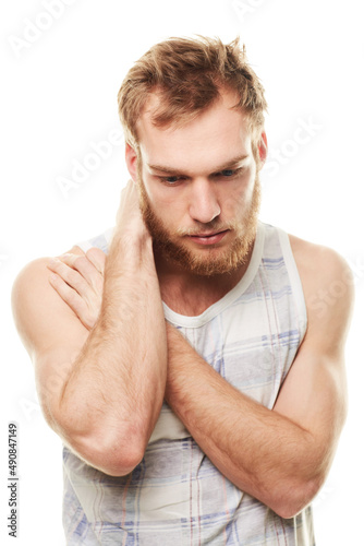 Feeling depressed. A young man wearing a vest and looking depressed isolated on white.