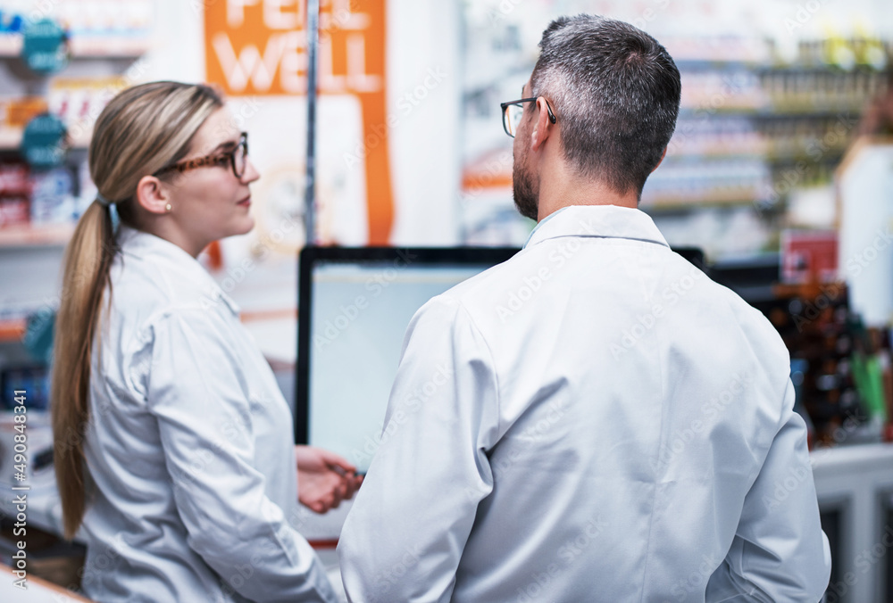 Theyve got your back for all your medical needs. Rearview shot of two pharmacists working in a pharmacy. Theyve got your back for all your medical needs. Rearview shot of two pharmacists working in a pharmacy.