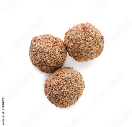 Delicious chocolate truffles on white background  top view