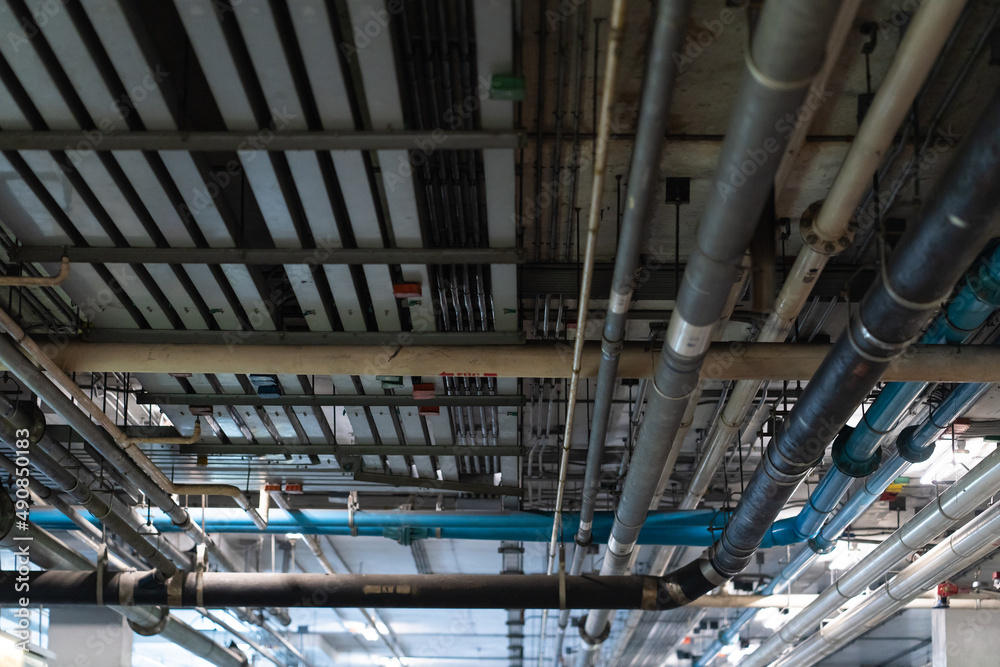 Mechanical and electrical services on the ceiling in a construction site.