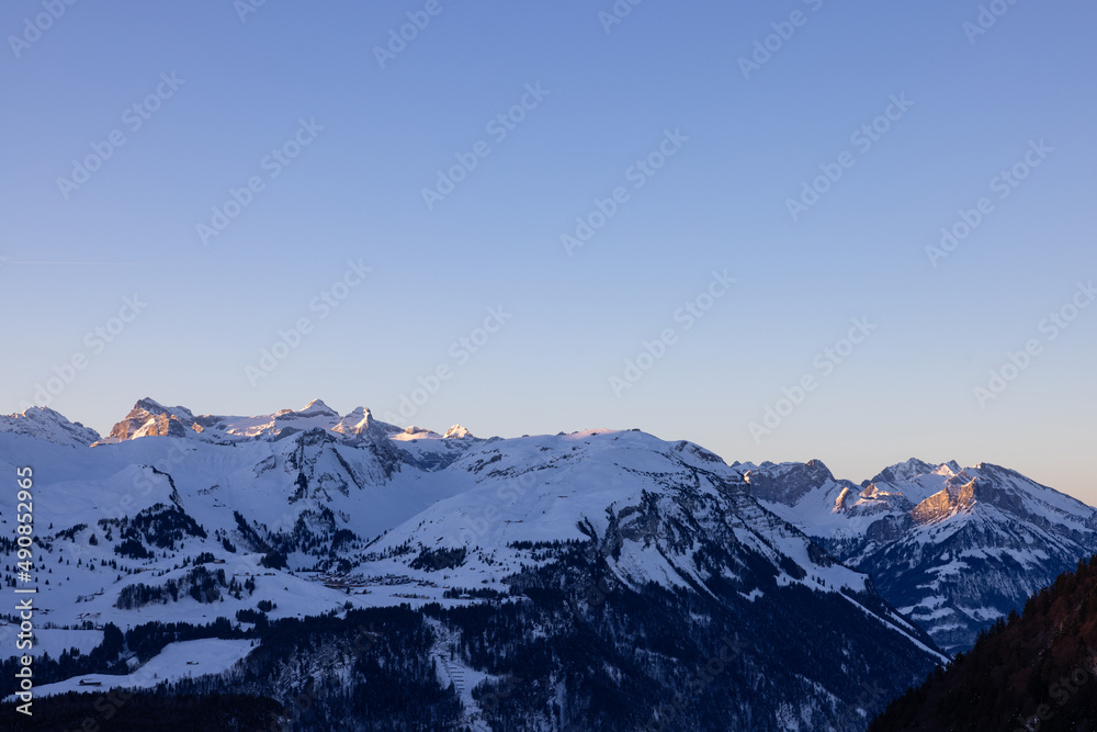 Amazing sunrise with a big mountain in front called Grosser Mythen with sun rays on top. Epic long exposure shot in the heart of Switzerland. Wonderful scenery with the mountain who get shined.