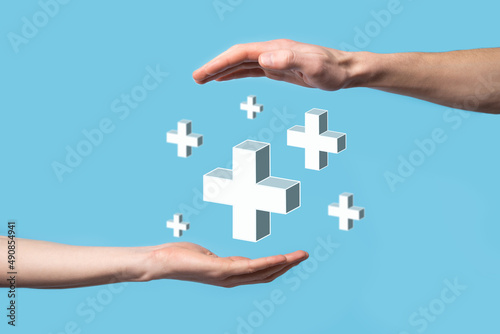 Hand hold 3D plus icon, man hold in hand offer positive thing such as profit, benefits, development, CSR represented by plus sign.The hand shows the plus sign