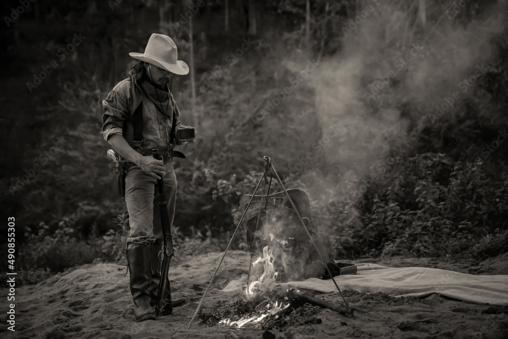 Naklejka premium Action image, vintage style of the cowboy group. Sit back and relax and have coffee in the evening camping.