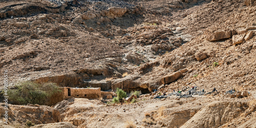 Bor Nekarot an above ground Nabaean Cistern southeast of the Makhtesh Ramon crater in Israel with mountain bikes in the foreground  and a rocky desert hillside in the background photo