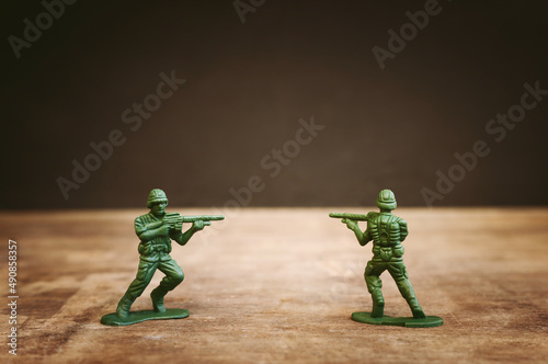 image of toy soldiers over wooden table photo