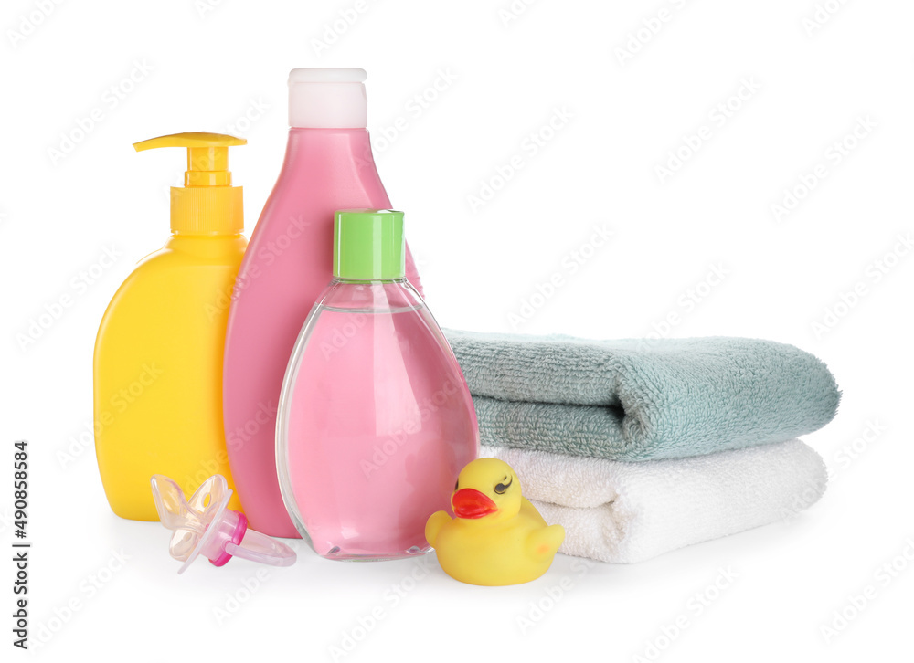 Bottle of baby oil, other cosmetic products and accessories on white background Bottle of baby oil, other cosmetic products and accessories on white background