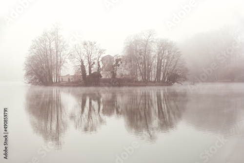 The island of memory drowned in the fog, in the heart of the lake Tête d'or in Lyon (France)